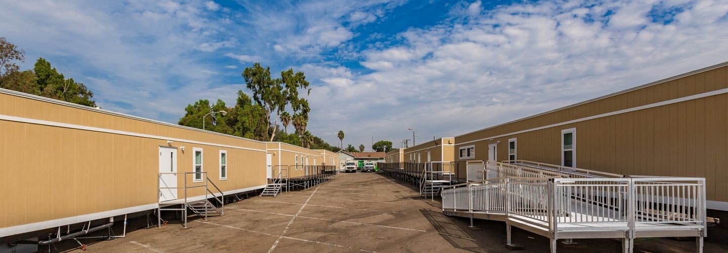 Two rows of modular commercial buildings with ramps and stairs